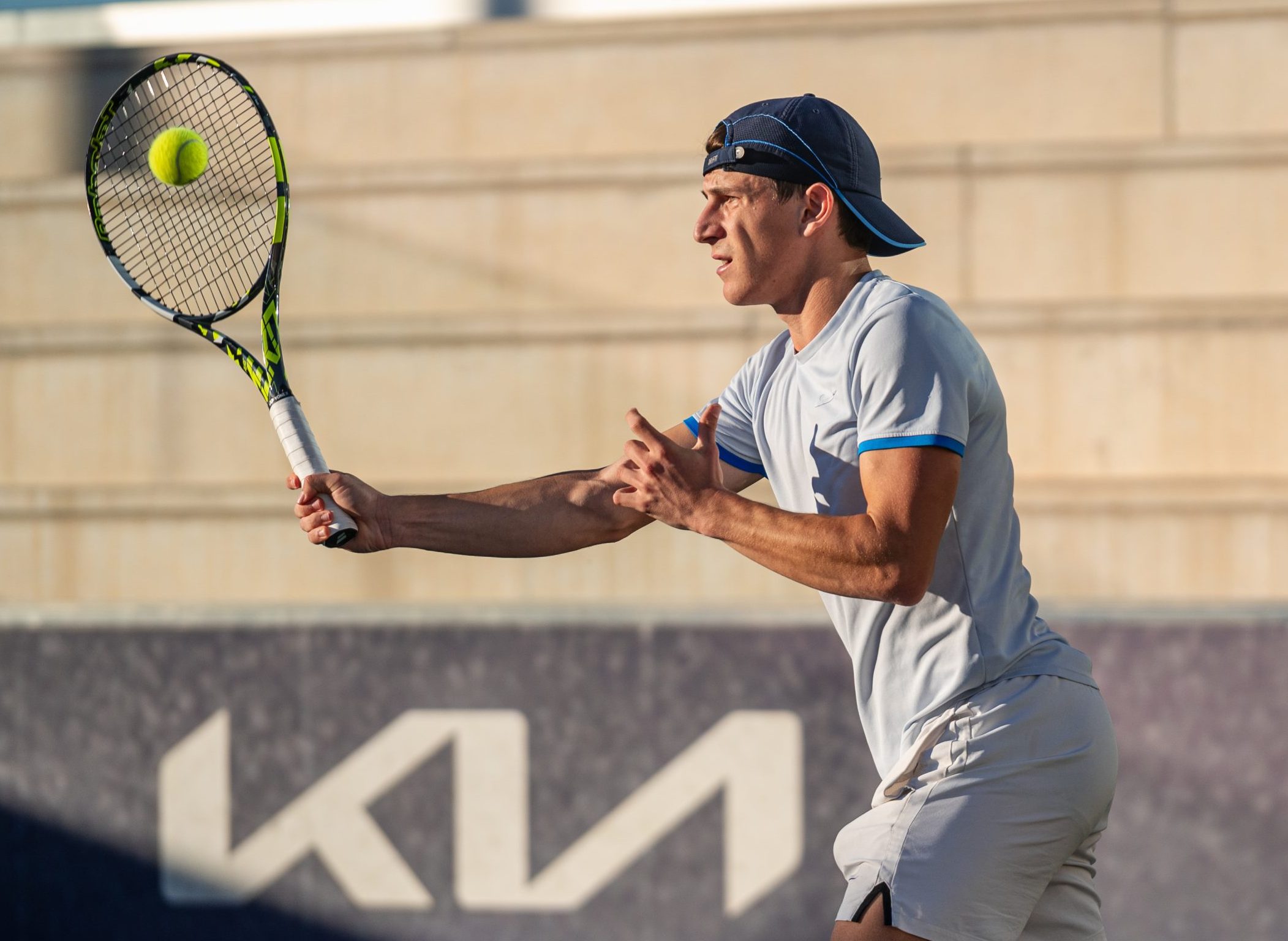 Adult tennis player training on court